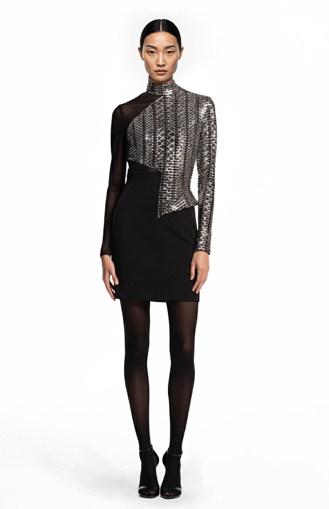 model is wearing a mini cocktail dress make of metallic and black crepe