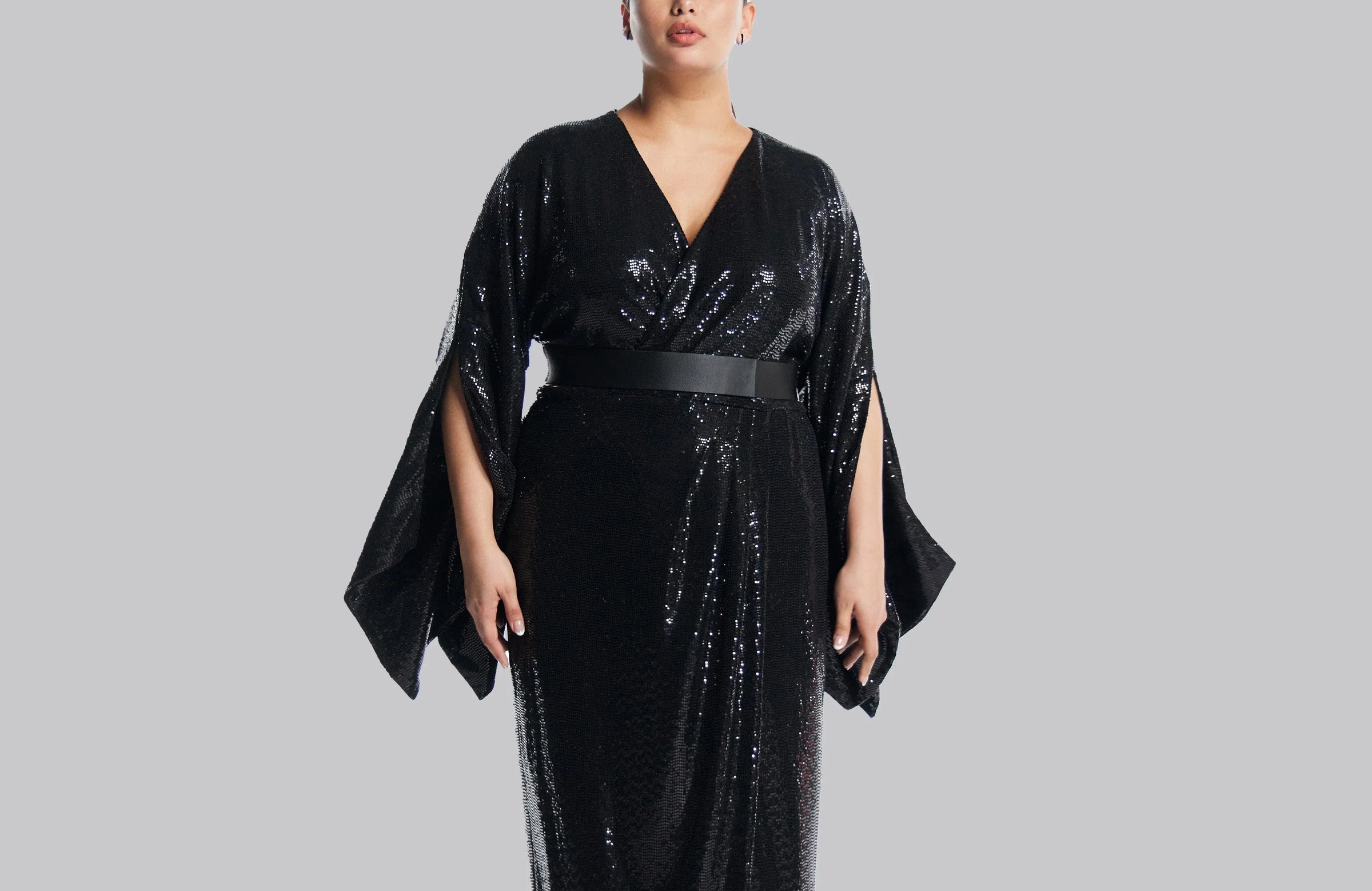 Elegant black gown with sequined sleeves.