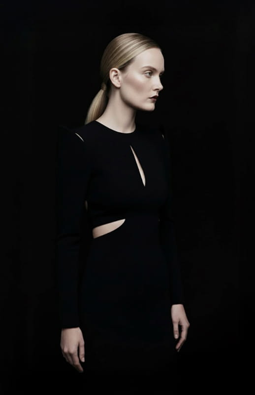 model is wearing sculptural black gown