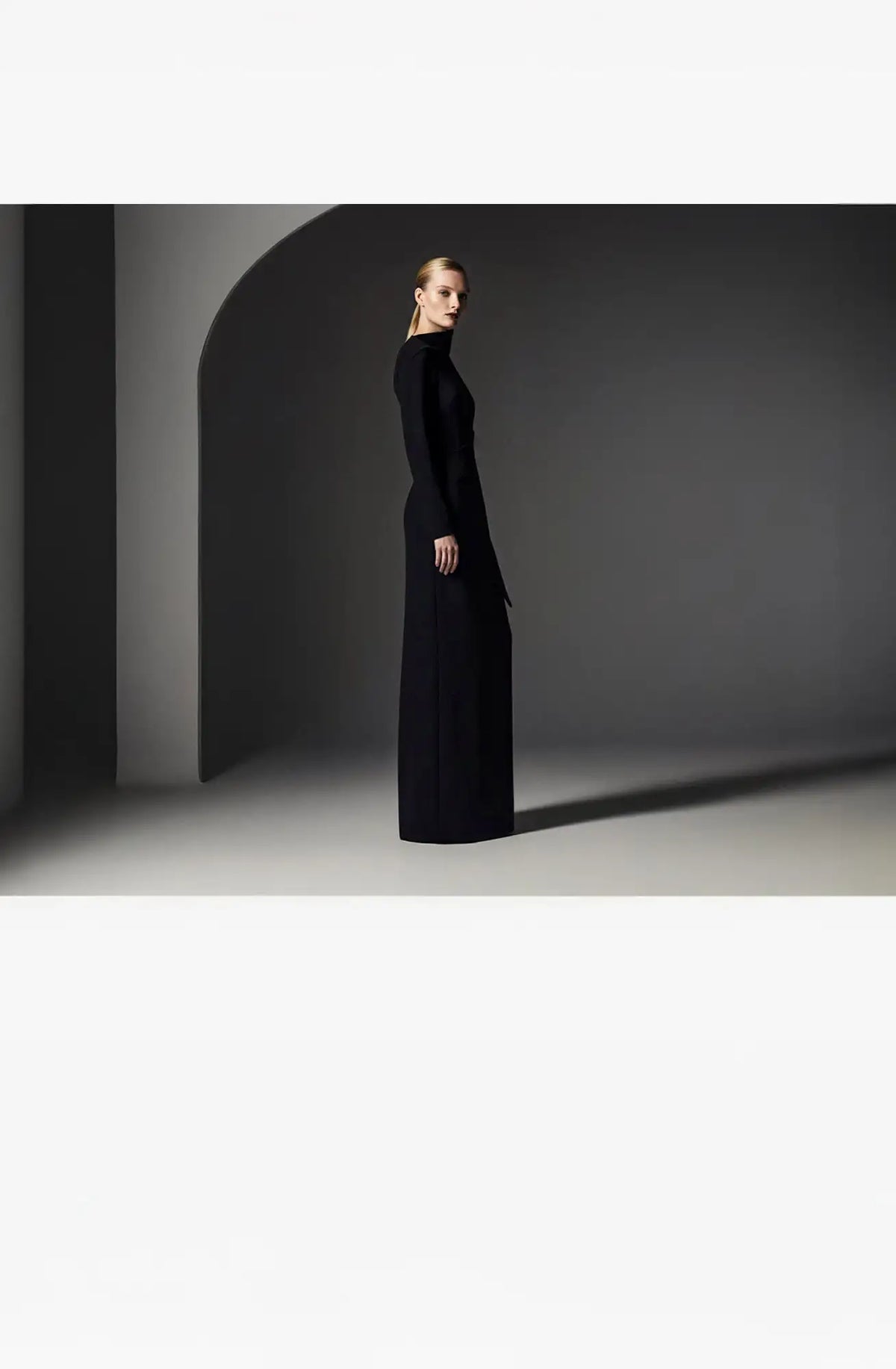 Black long-sleeved maxi dress with a minimalist design.