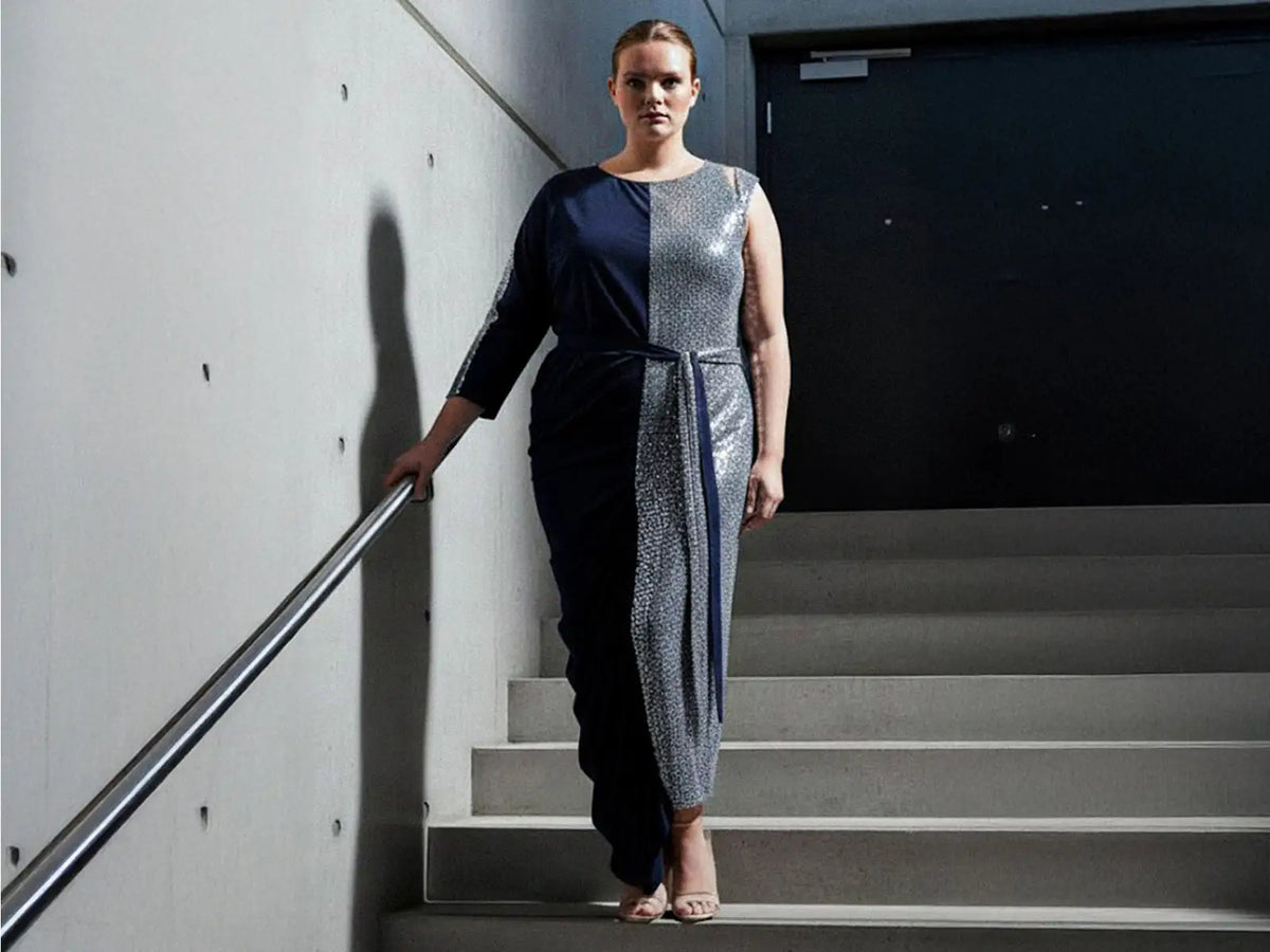 Navy blue and silver sequined jumpsuit with metallic stripes.