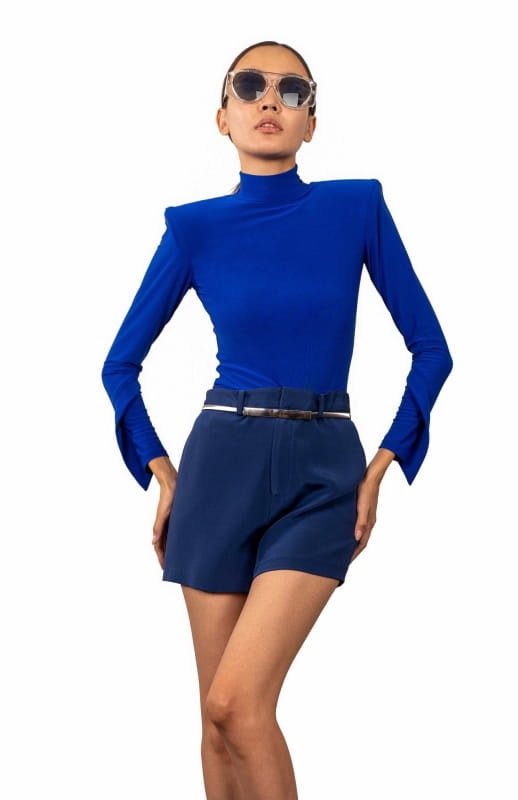 Royal blue, high shoulder pad bodysuit with a turtleneck and long draped sleeves.