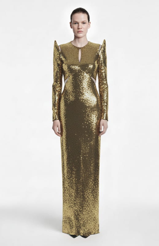 model is wearing long sleeve, long gold sequin dress with cutouts