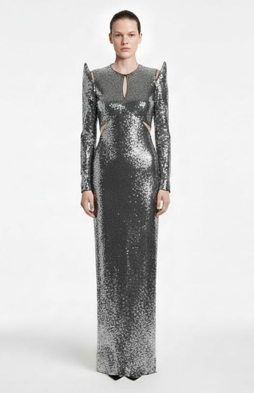 model is wearing long sleeve, long silver sequin dress with cutouts
