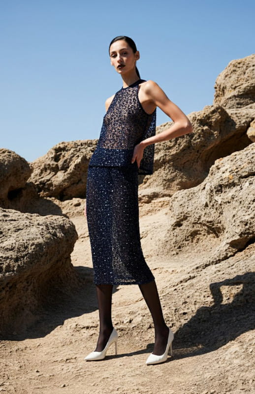 model is wearing beaded tank top and skirt