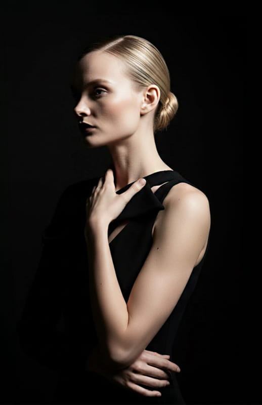 model is wearing asymmetrical long black dress