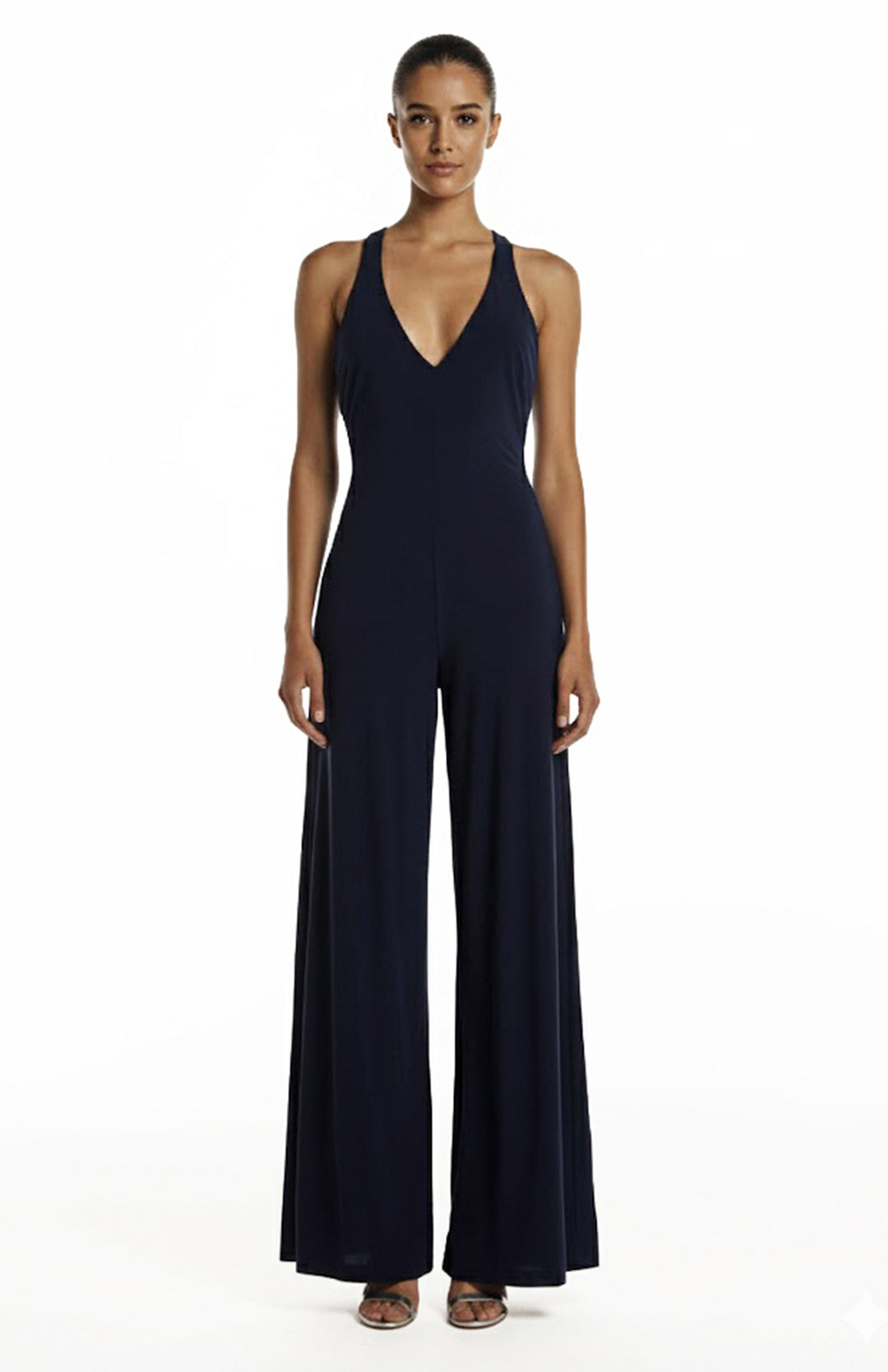 model is wearing a deep V neck navy jumpsuit