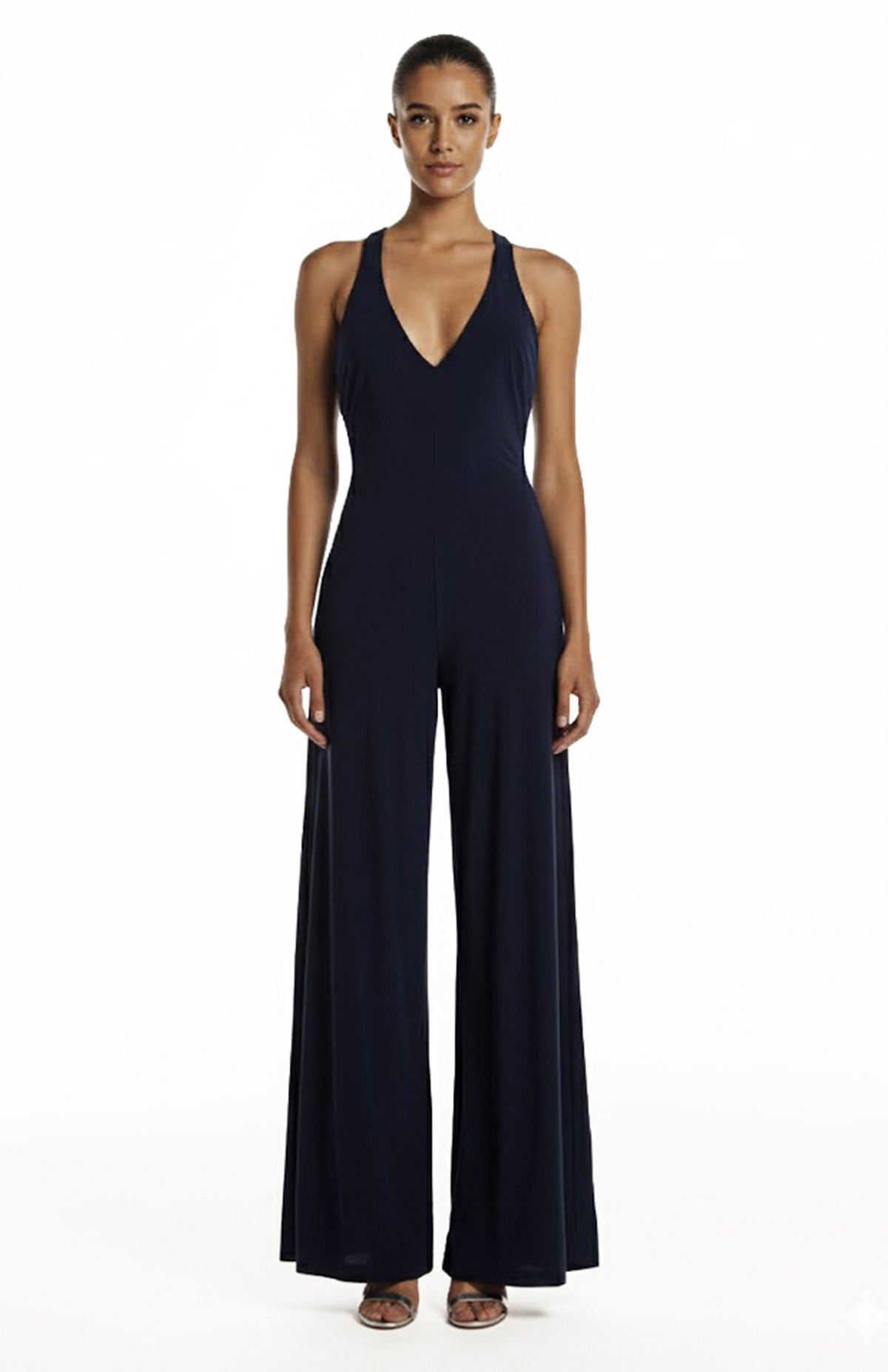 model is wearing a deep V neck navy jumpsuit