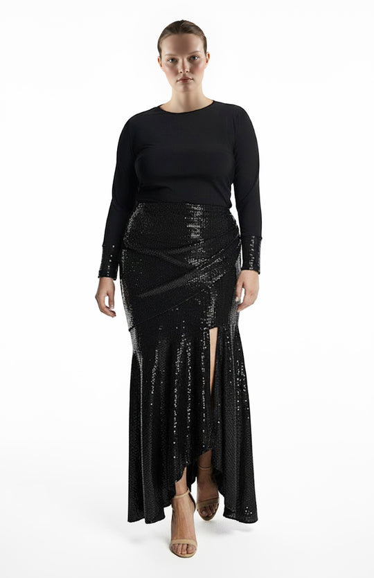 plus size model is wearing black turtleneck top and draped black sequin skirt