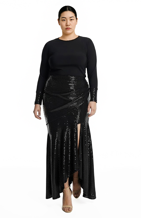 plus size model is wearing black turtleneck top and draped black sequin skirt
