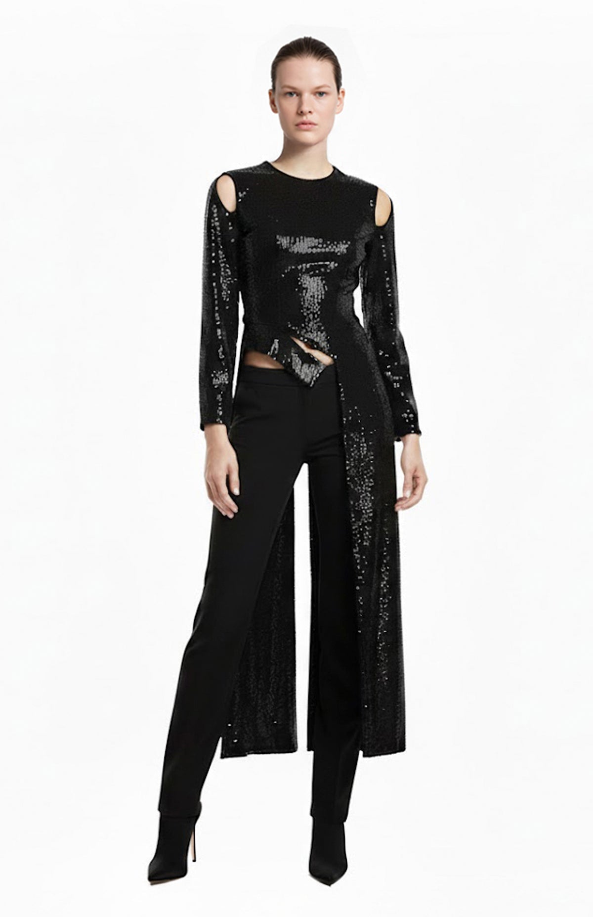 Model wearing black sequin top with long tails and black pants
