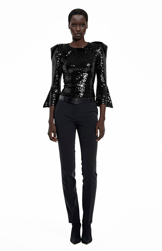 black model wearing black sequin top and black pants