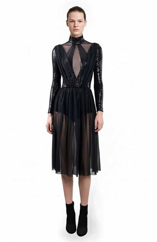 Model wearing black sequin bodysuit dress with sheer skirt and panels