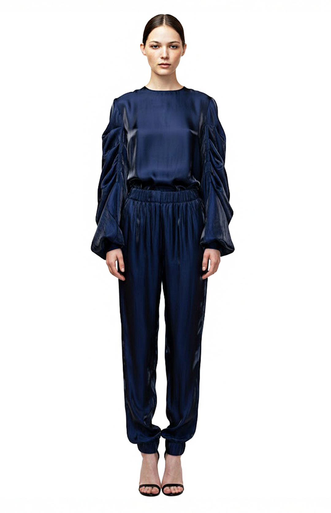 model is wearing a draped satin blouse in navy