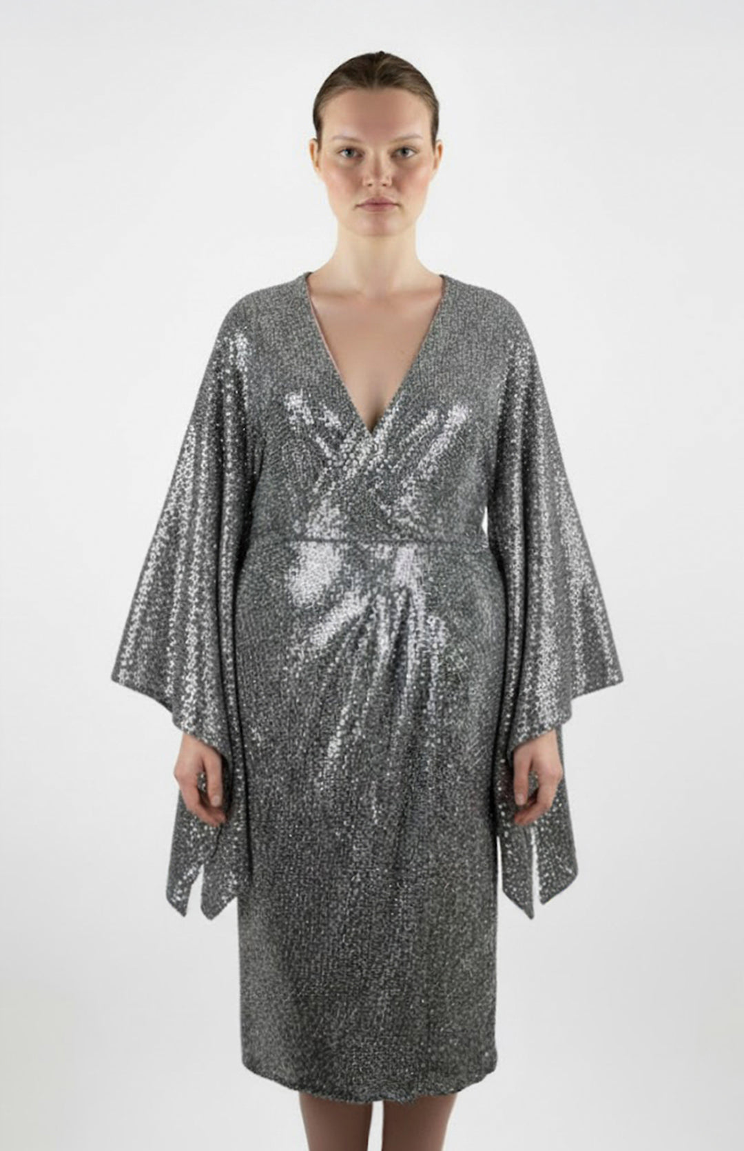 plus size model wearing silver sequin cocktail dress