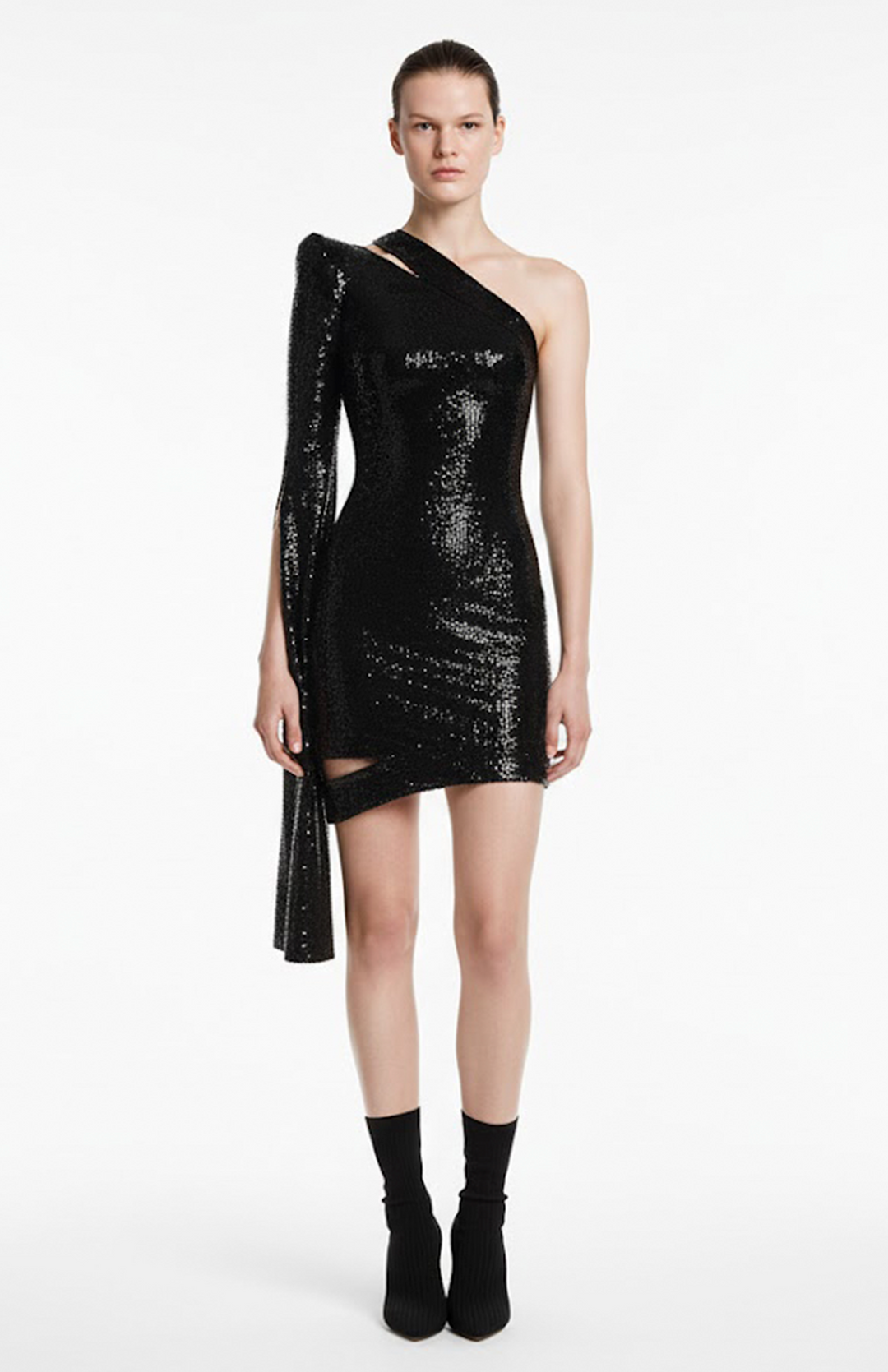 Model wearing one shoulder mini sequin dress with cutouts