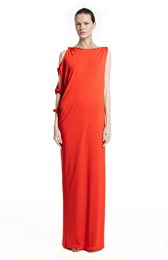 model is wearing a draped orange jersey gown