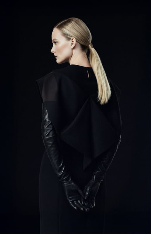 model wearing black couture draped top