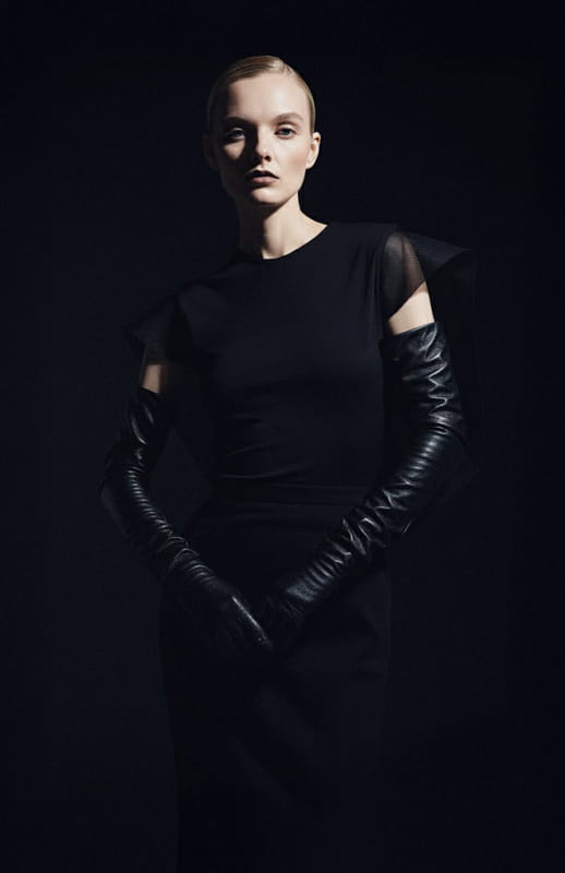model wearing black couture top with draped silk organza back details