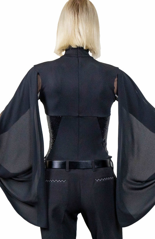 Stylish, black designer bodysuit with turtleneck, sheer neckline and sleeves, draped cape, and sequin contrast panels.