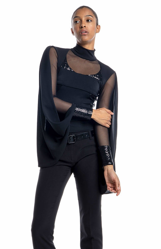 Elegant, black designer bodysuit with turtleneck, sheer neckline and sleeves, draped cape, and sequin contrast panels.