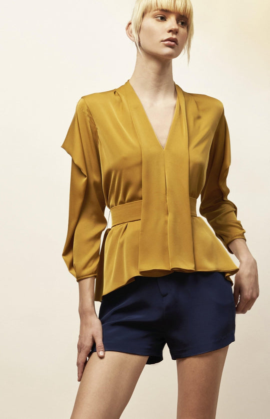 Chic, belted, satin blouse in gold.