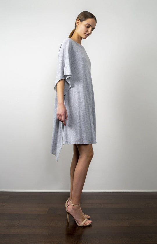 Sexy chic,smart casual, asymmetrical sleeve, asymmetrical hem,  short, kimono style dress in lux heather grey jersey knit. With back slash detail. Fully lined.