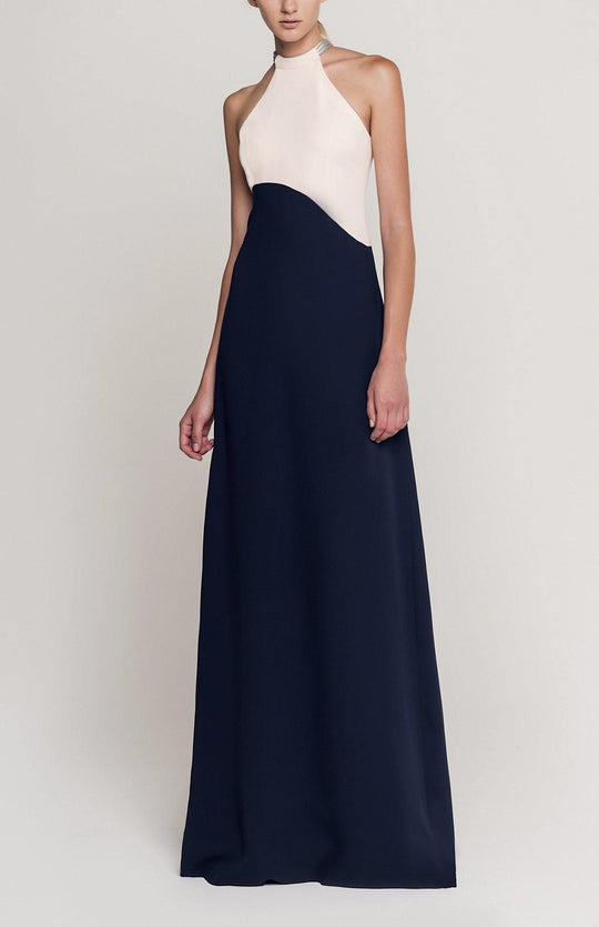 Blush and navy long, sleeveless, colorblock dress in double silk crepe with a futuristic silver neck trim detail.