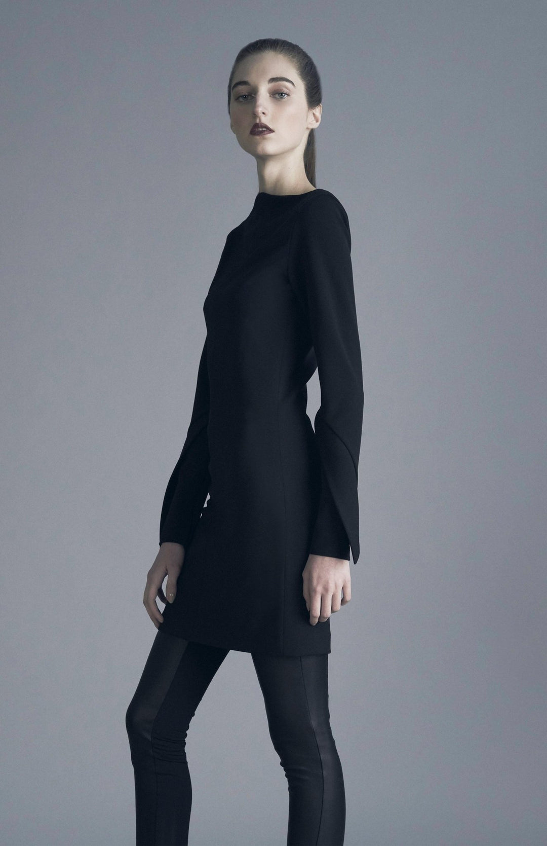 Chic, black, long sleeve short fitted dress, with high neck, long sleeves, made in stretch crepe.