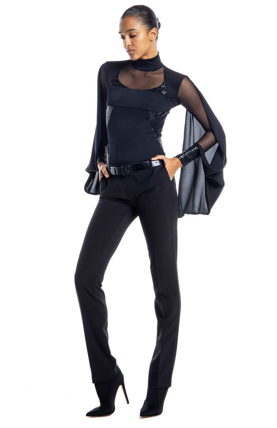 Black designer bodysuit with turtleneck, sheer neckline and sleeves, draped cape, and sequin contrast panels.