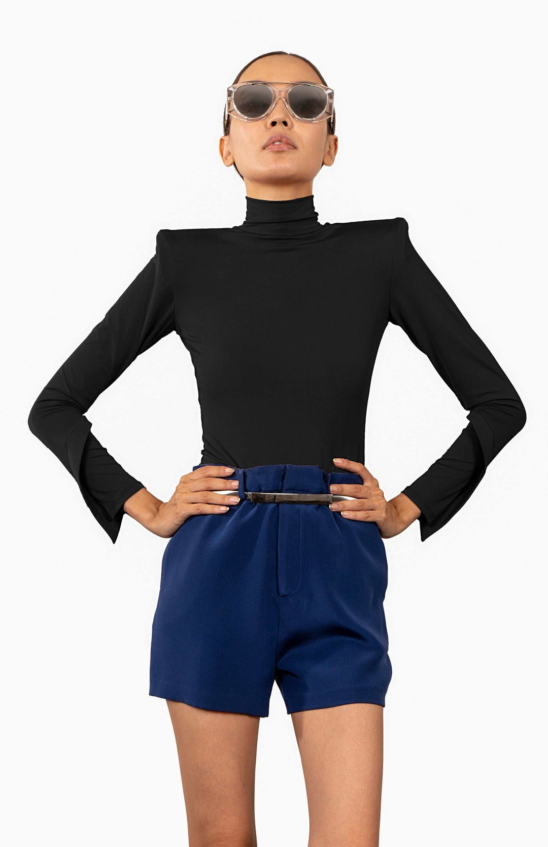Black,  high shoulder pad bodysuit with a turtleneck and long draped sleeves.