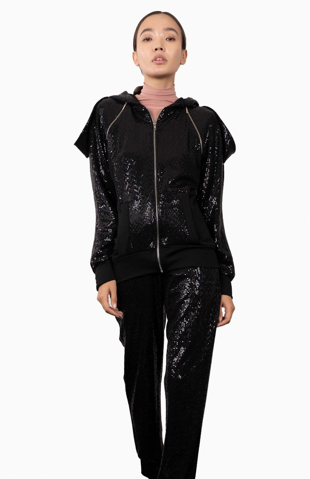 Chic, black, designer, sequin hoodie with an oversized, lined hood, decorative zippers and draped shoulders.