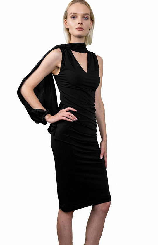 Black, Grecian style, draped dress in jersey knit, with an asymmetrical oversized sleeve.