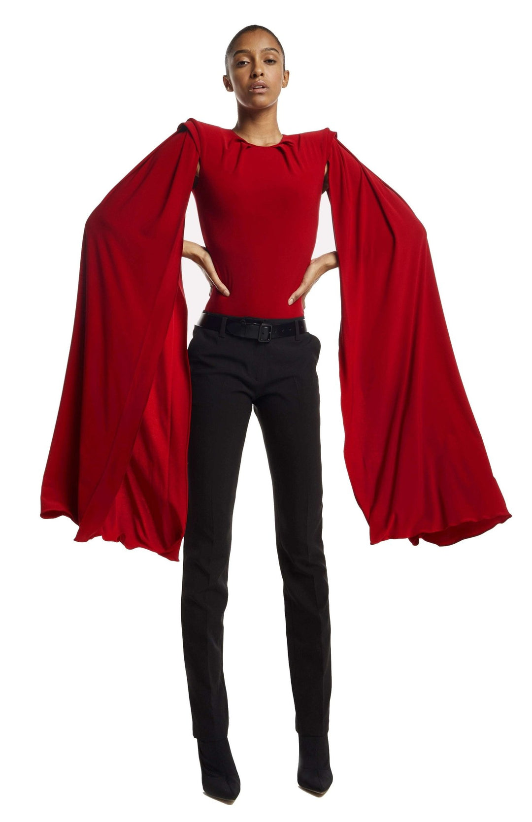 Red draped bodysuit with shoulder pads and oversized cape sleeves