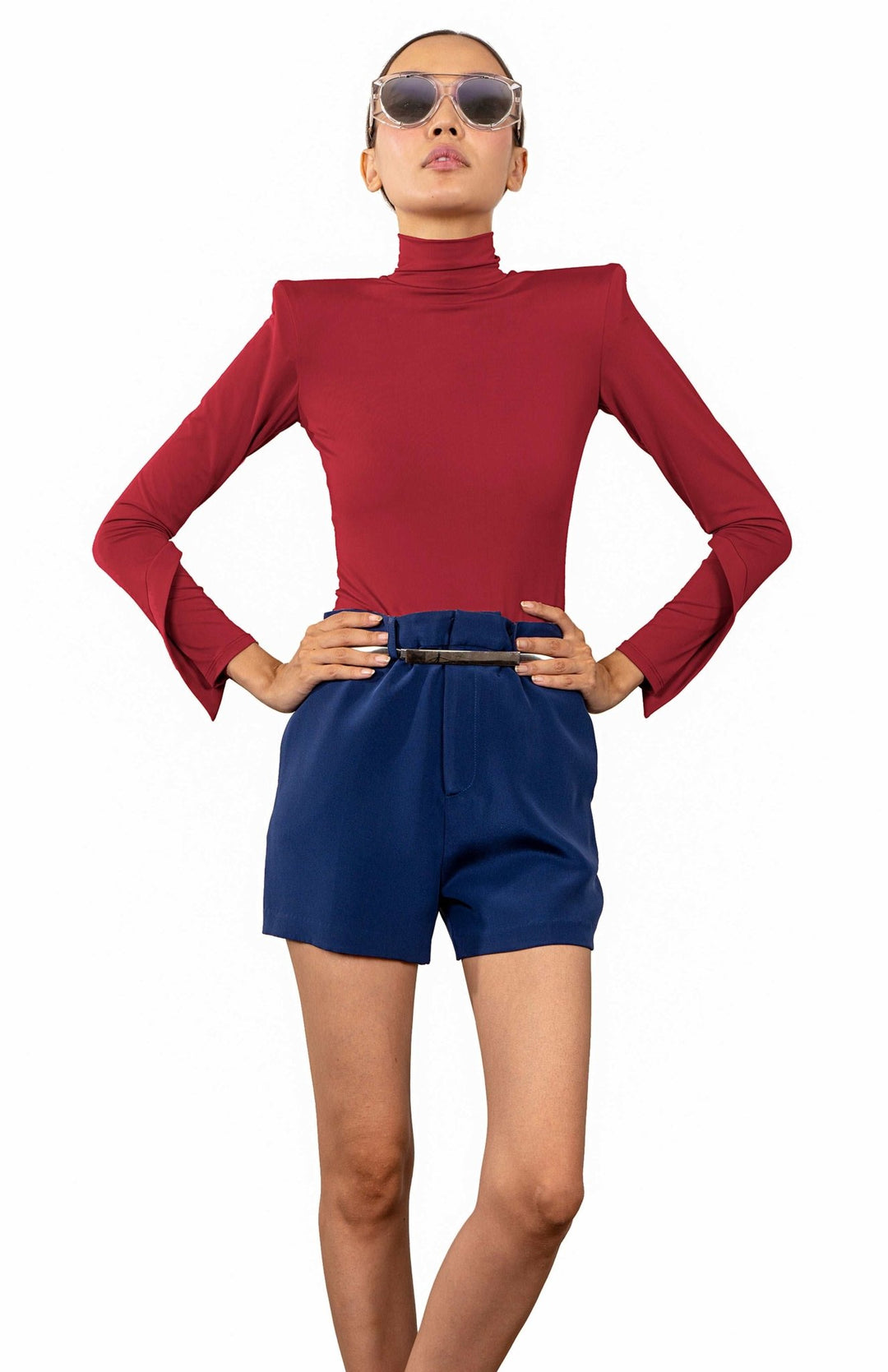 Red, high shoulder pad bodysuit with a turtleneck and long draped sleeves.
